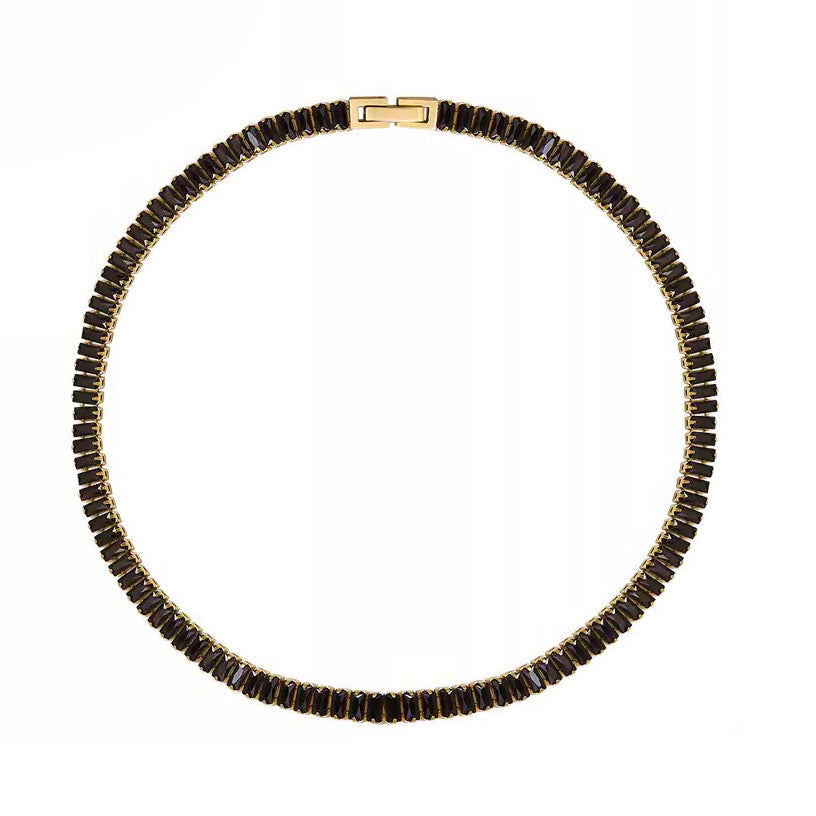 Necklace with black beads and gold clasp on a white background
